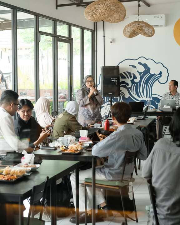 Moikai Coffee interior with wave mural and event speaker