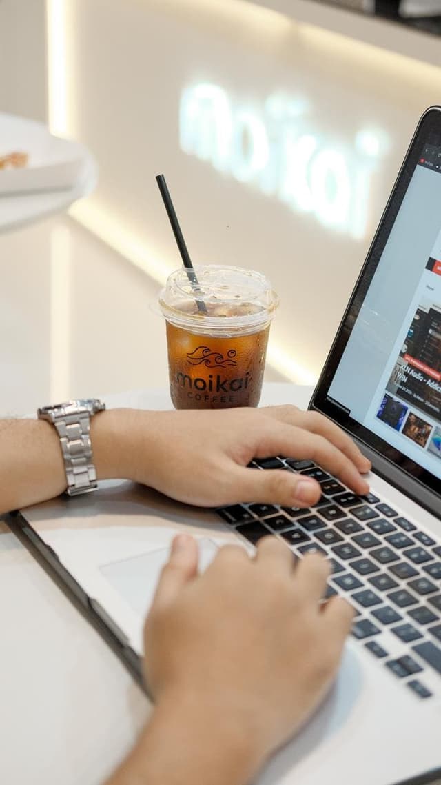 Remote working setup with iced coffee